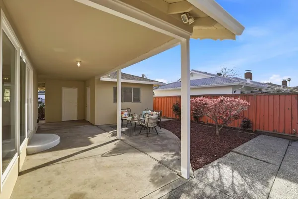 a view of a patio with a table and chairs