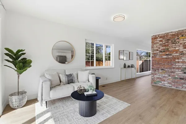 a living room with furniture and a potted plant