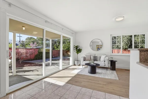 a living room with fireplace furniture and a large window