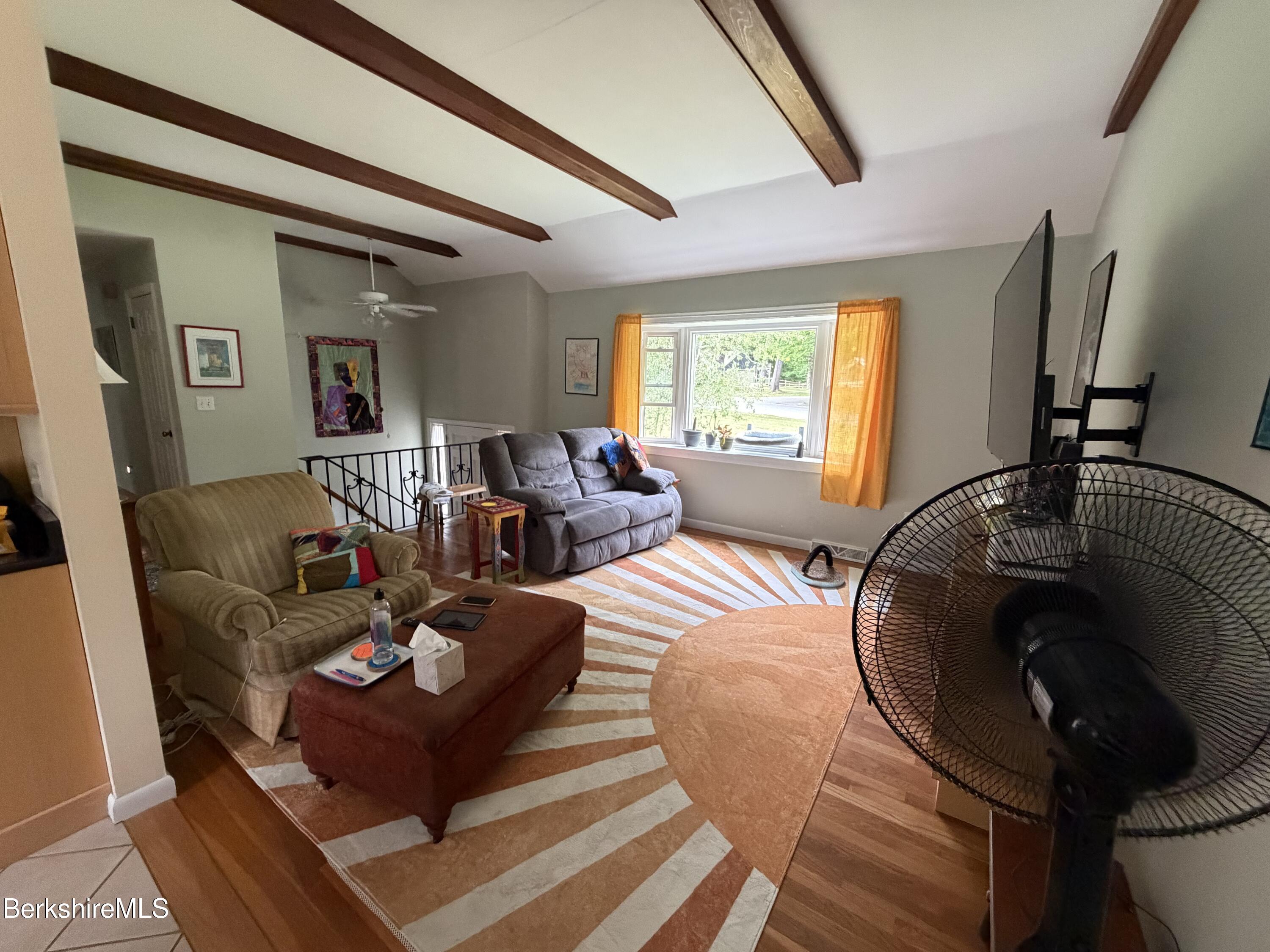 20 Sullivan Lane Lenox, MA 01240 - Photo 5 of 23 a living room with furniture and a large window