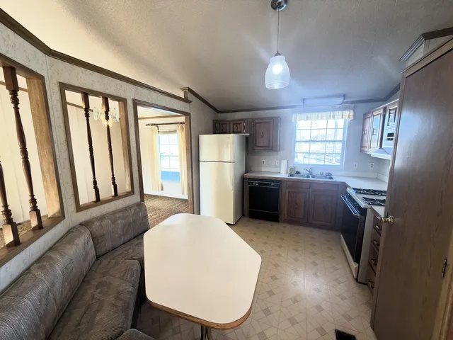 a kitchen with stainless steel appliances a refrigerator and cabinets