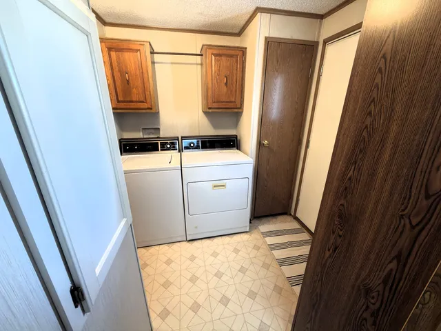 a view of a hallway view with wooden floor and a living room