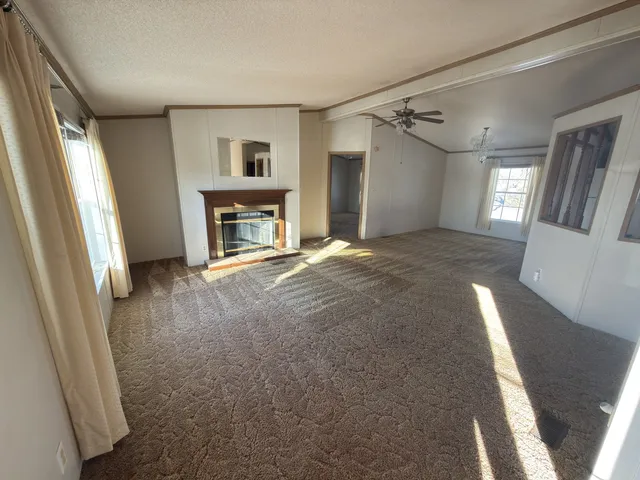 a view of livingroom with fireplace and window