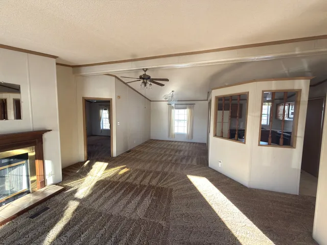 a view of empty room with window and fireplace