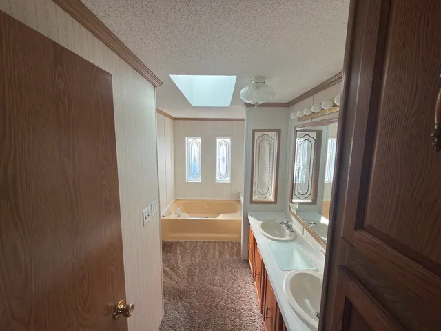 a bathroom with a tub a toilet and a sink