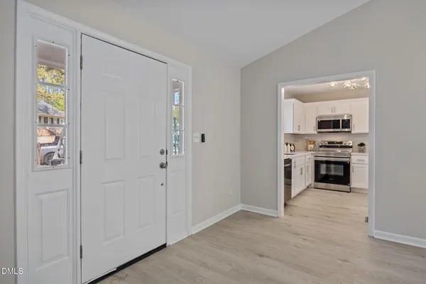 a view of kitchen with stainless steel appliances a stove and a refrigerator