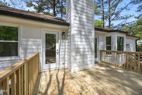 a view of balcony with wooden floor and fence
