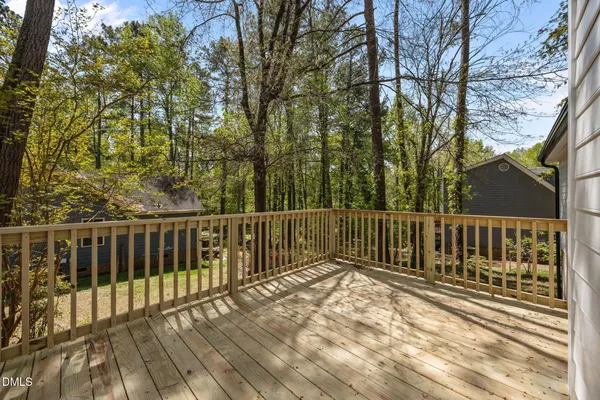 a view of a wooden fence and trees