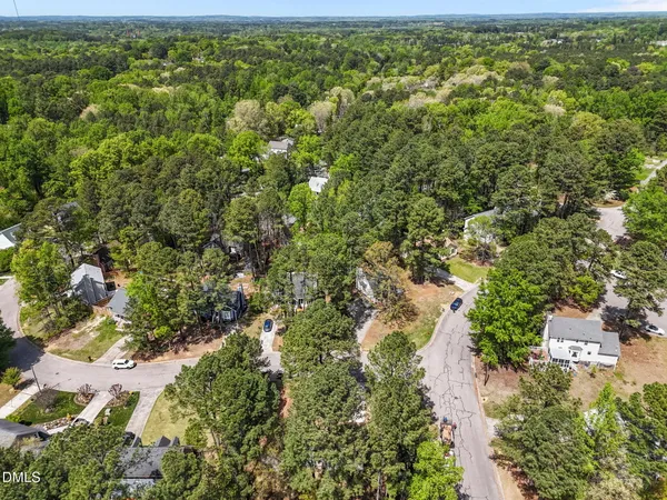 an aerial view of a house with a yard and garden
