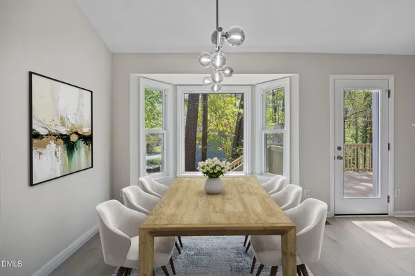 a dining room with furniture a chandelier and window
