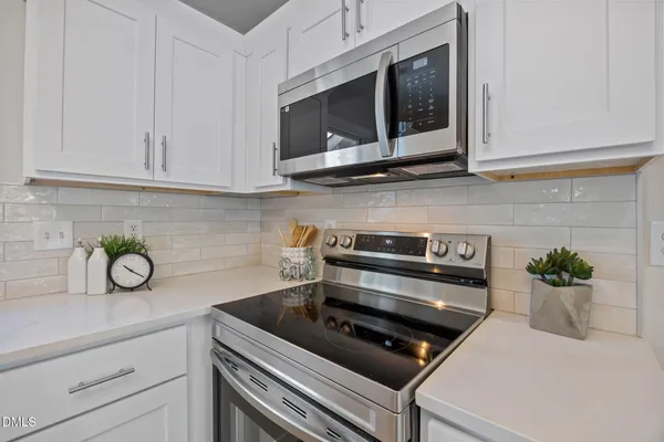 a kitchen with a stove and a microwave