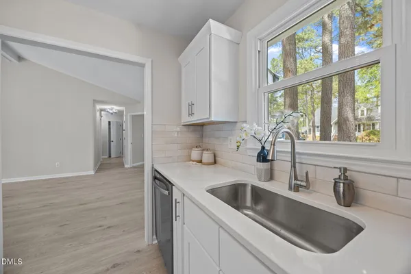 a kitchen with a sink cabinets and window