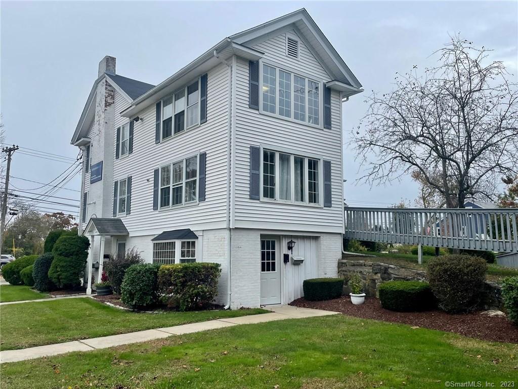 a front view of a house with a garden and plants