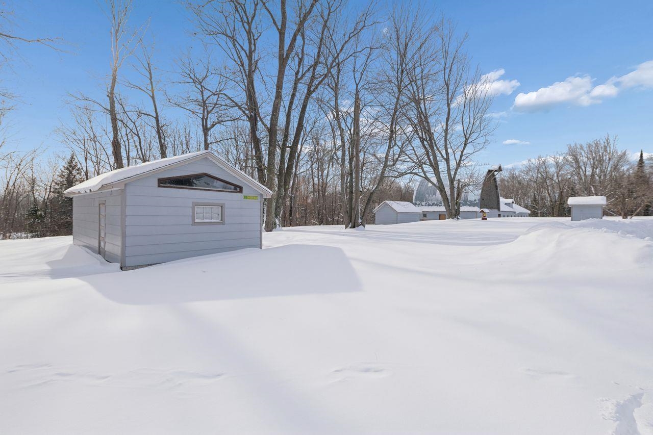 65915 Selke Road Mason, WI 54856 - Photo 31 of 33 Yard layered in snow featuring an outbuilding