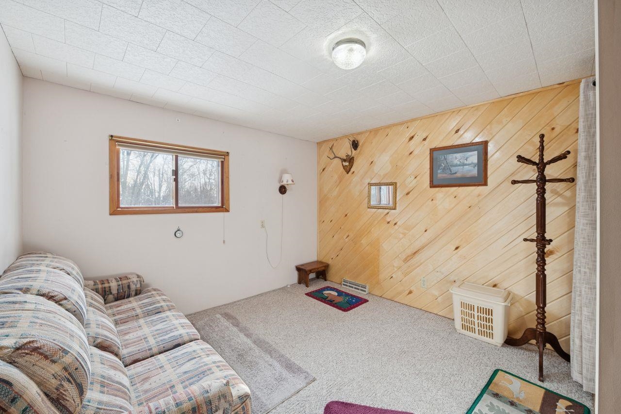 65915 Selke Road Mason, WI 54856 - Photo 5 of 33 Living room with wooden walls and carpet floors