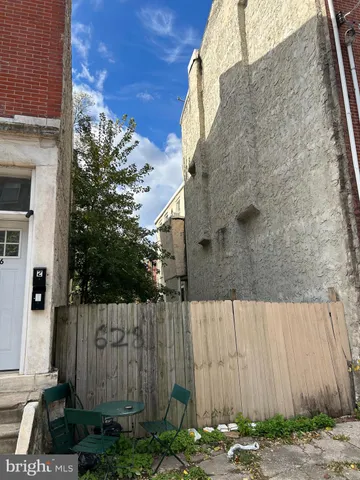 a side view of a house with a backyard