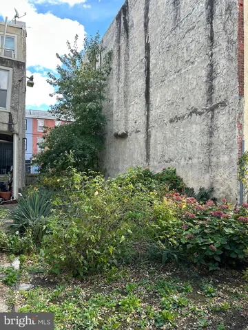 a view of a garden with a building