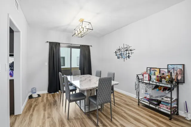 a view of a dining room with furniture wooden floor and a rug