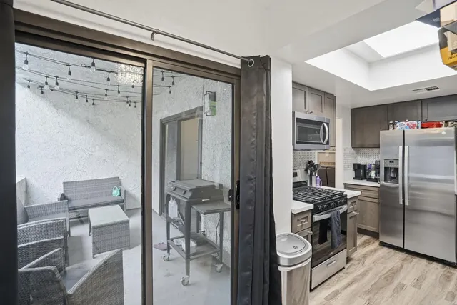 a kitchen with stainless steel appliances granite countertop a refrigerator and a stove