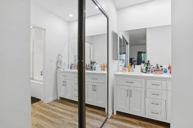 a spacious bathroom with a double vanity sink and mirror