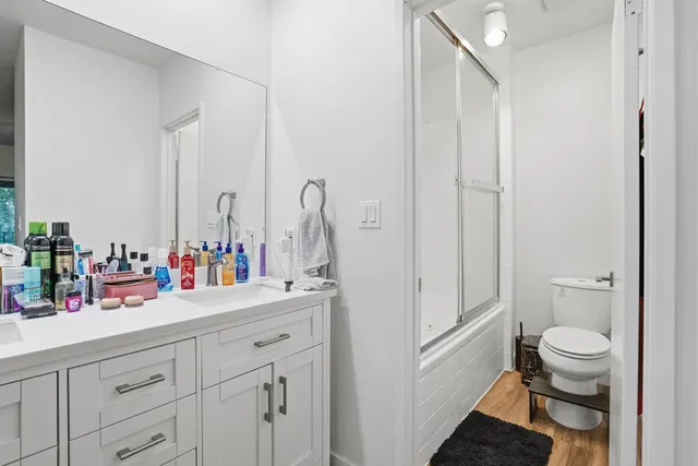 a bathroom with a sink a toilet and a mirror