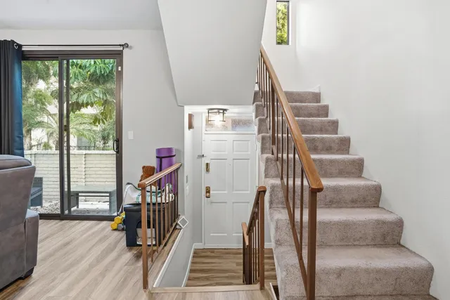 a view of entryway with wooden floor and stairs