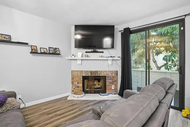a living room with a fireplace and a flat screen tv