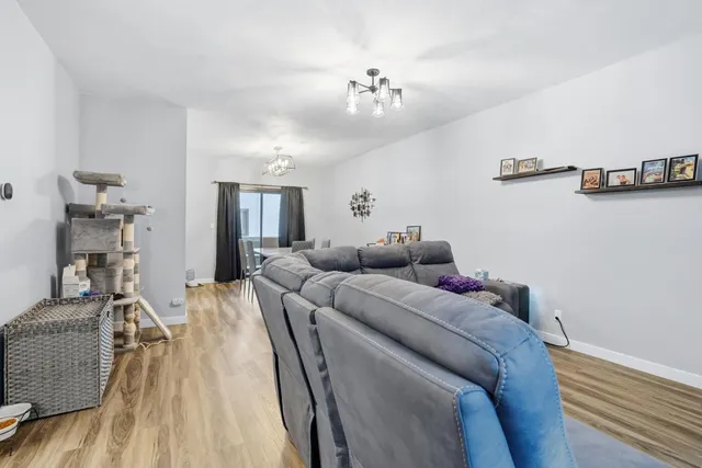 a bed room with a bed and a chandelier