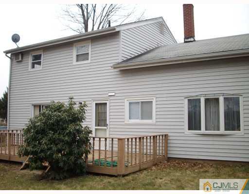 17 Magee Road Edison, NJ 08817 - Photo 2 of 10 a view of a house with a yard and potted plants
