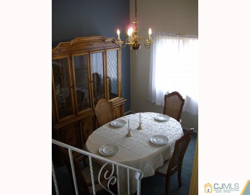 17 Magee Road Edison, NJ 08817 - Photo 3 of 10 a dining room with furniture and chandelier