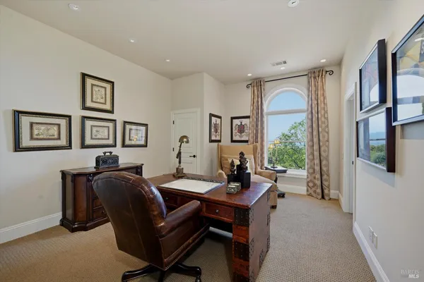 a bathroom with a granite countertop sink a large mirror and a large window