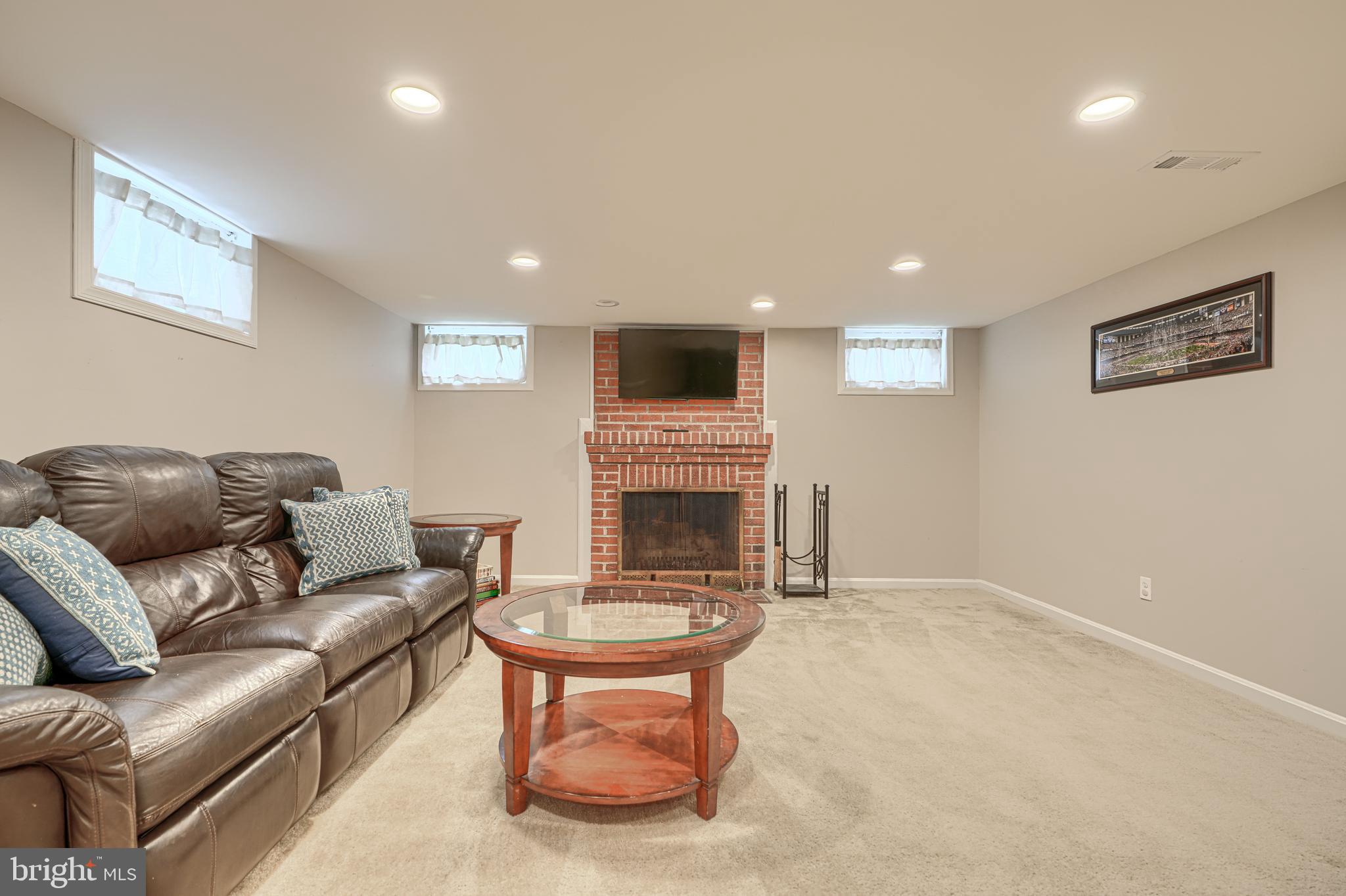 8132 Pleasant Plains Road Towson, MD 21286 - Photo 35 of 55 a living room with furniture a fireplace and a flat screen tv