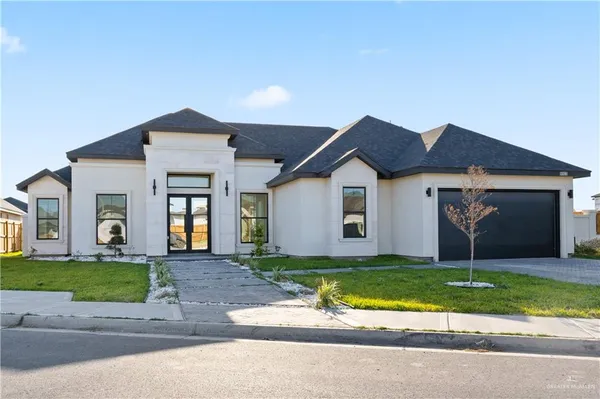 a front view of a house with a yard and garage