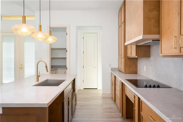 a kitchen with a sink cabinets and wooden floor