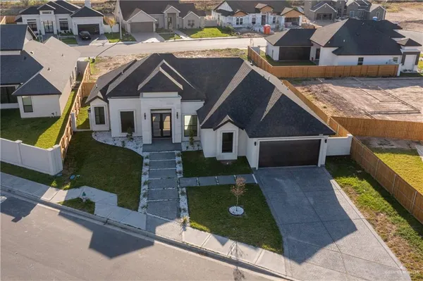 an aerial view of a house with a yard