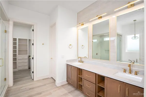 a bathroom with a double vanity sink mirror and double