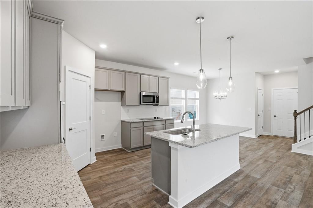 5351 Tolar Road South Fulton, GA 30213 - Photo 7 of 30 a kitchen with kitchen island a sink stainless steel appliances and cabinets