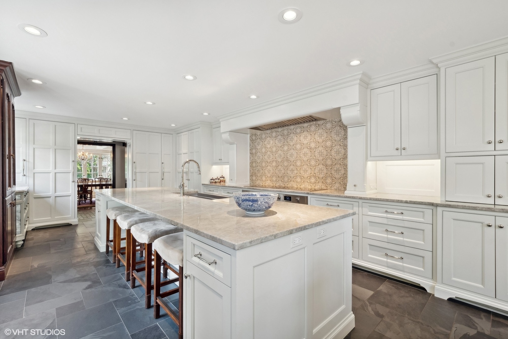 885 Maplewood Road Lake Forest, IL 60045 - Photo 12 of 78 a kitchen with a stove a sink a refrigerator and white cabinets with wooden floor