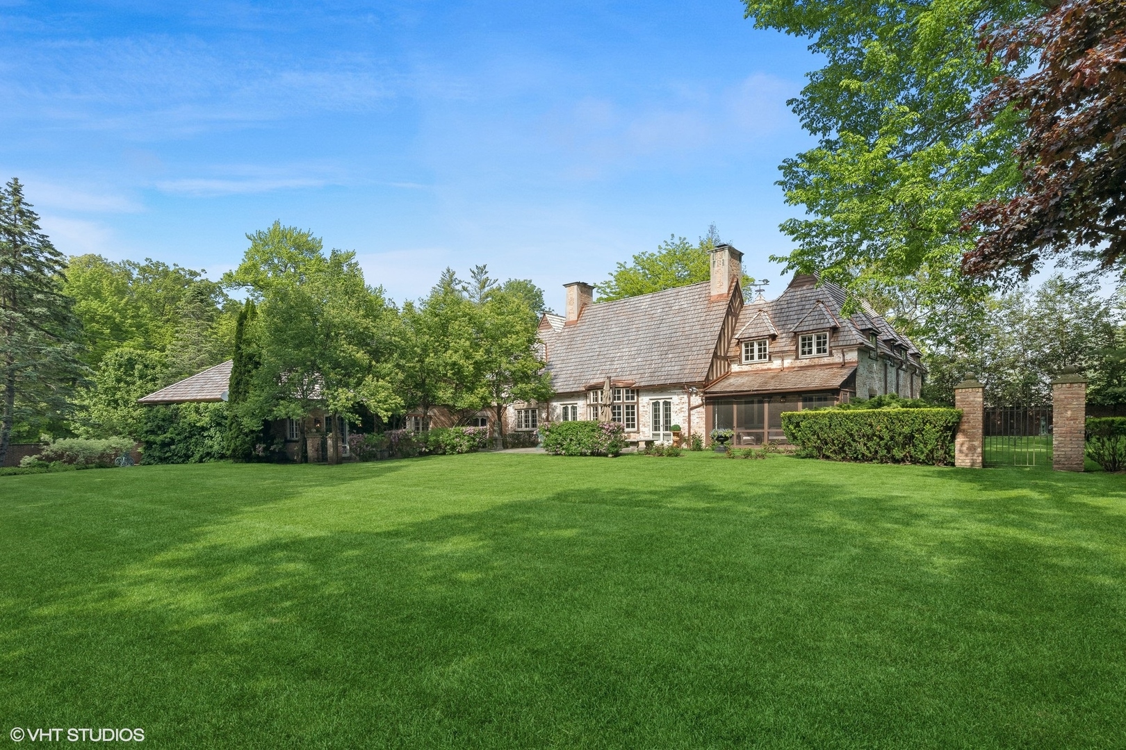 885 Maplewood Road Lake Forest, IL 60045 - Photo 58 of 78 a view of a house with a big yard potted plants and large tree