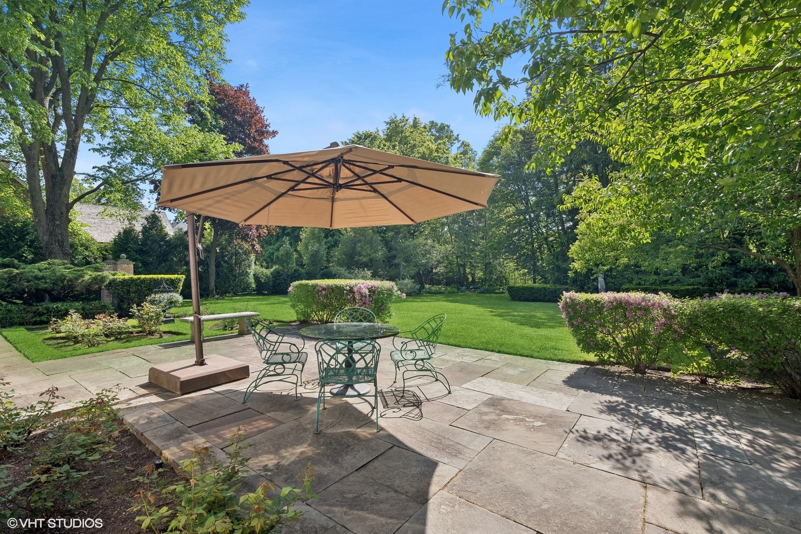 885 Maplewood Road Lake Forest, IL 60045 - Photo 61 of 78 a view of a chair and table under an umbrella