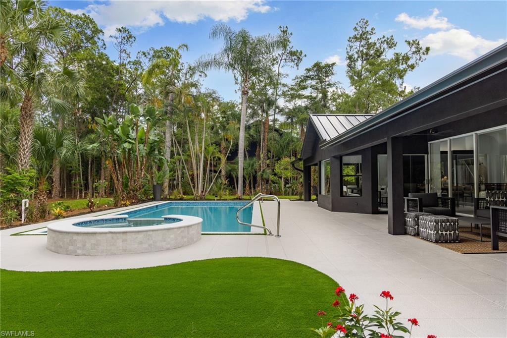 4521 3rd Avenue Northwest Naples, FL 34119 - Photo 25 of 46 a view of a house with swimming pool and sitting area