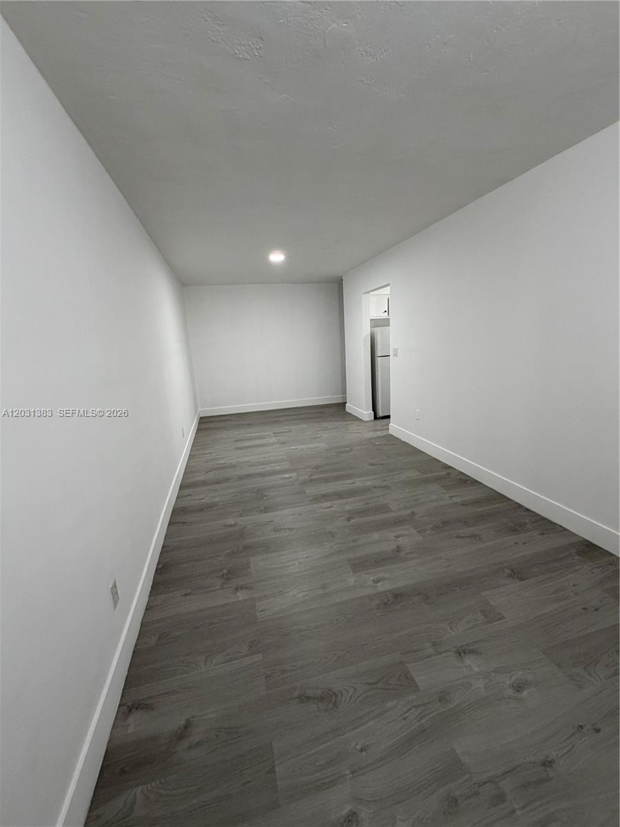 324 Surfside Boulevard, Unit 7 Surfside, FL 33154 - Photo 2 of 8 a view of a hallway with wooden floor