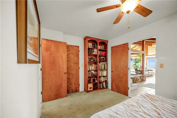 a view of a bedroom with a window and a kitchen