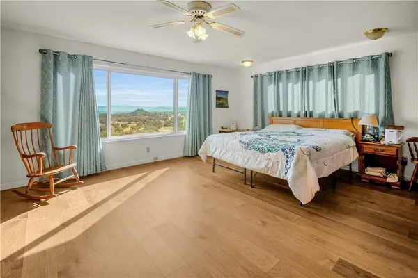 a spacious bedroom with a bed and a chandelier