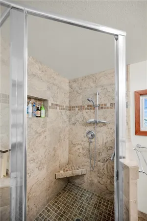 a bathroom with a glass shower door