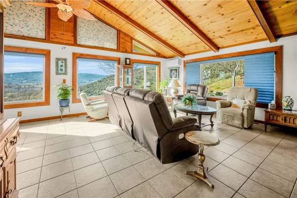 a living room with patio furniture and a floor to ceiling window