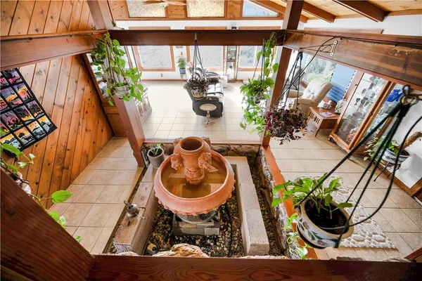 a view of house with backyard and sitting area