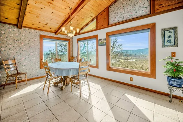 a dining room with furniture and a potted plant