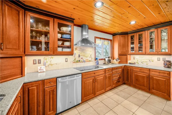 a kitchen with granite countertop sink and cabinets