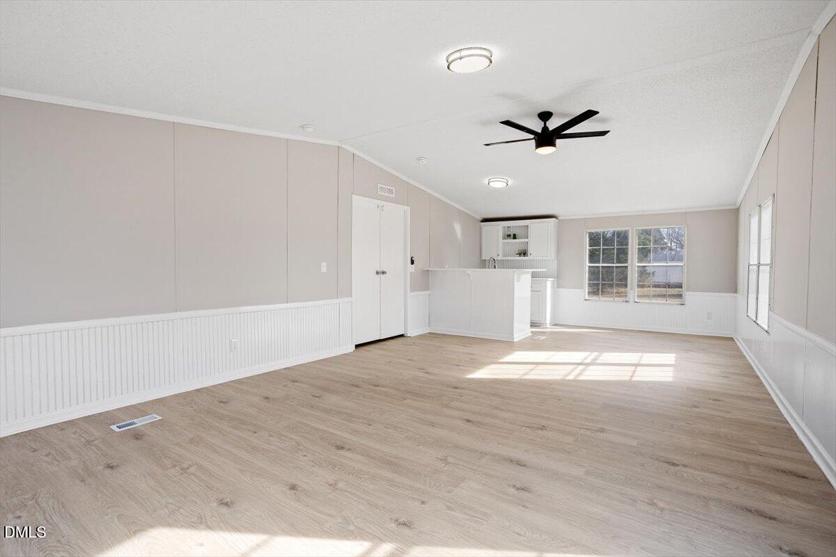 371 Woodland Church Road Dudley, NC 28333 - Photo 11 of 30 a view of empty room with wooden floor and fan